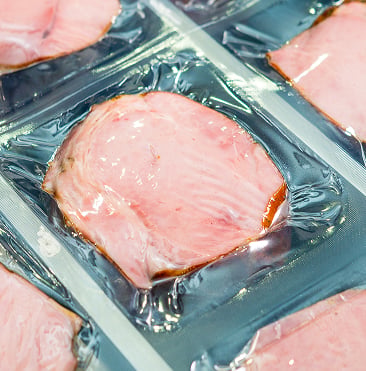 Workers performing various roles in meat processing industry